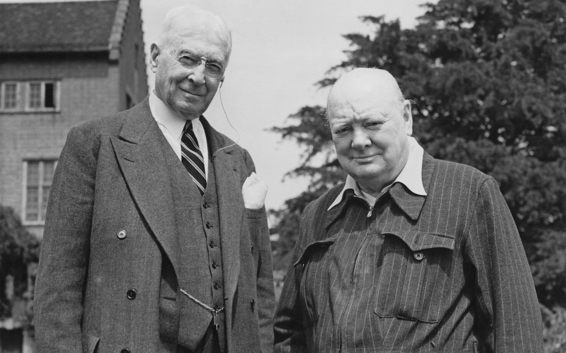 British statesman Winston Churchill (1874 - 1965) welcomes his friend Bernard Baruch (1870 - 1965) to his home at Chartwell in Kent, July 1949. Baruch is an American financier and political consultant. Churchill is wearing his famous 'siren suit', a pinstriped grey wool suit which he wore through the air raids. (Photo by Central Press/Hulton Archive/Getty Images)