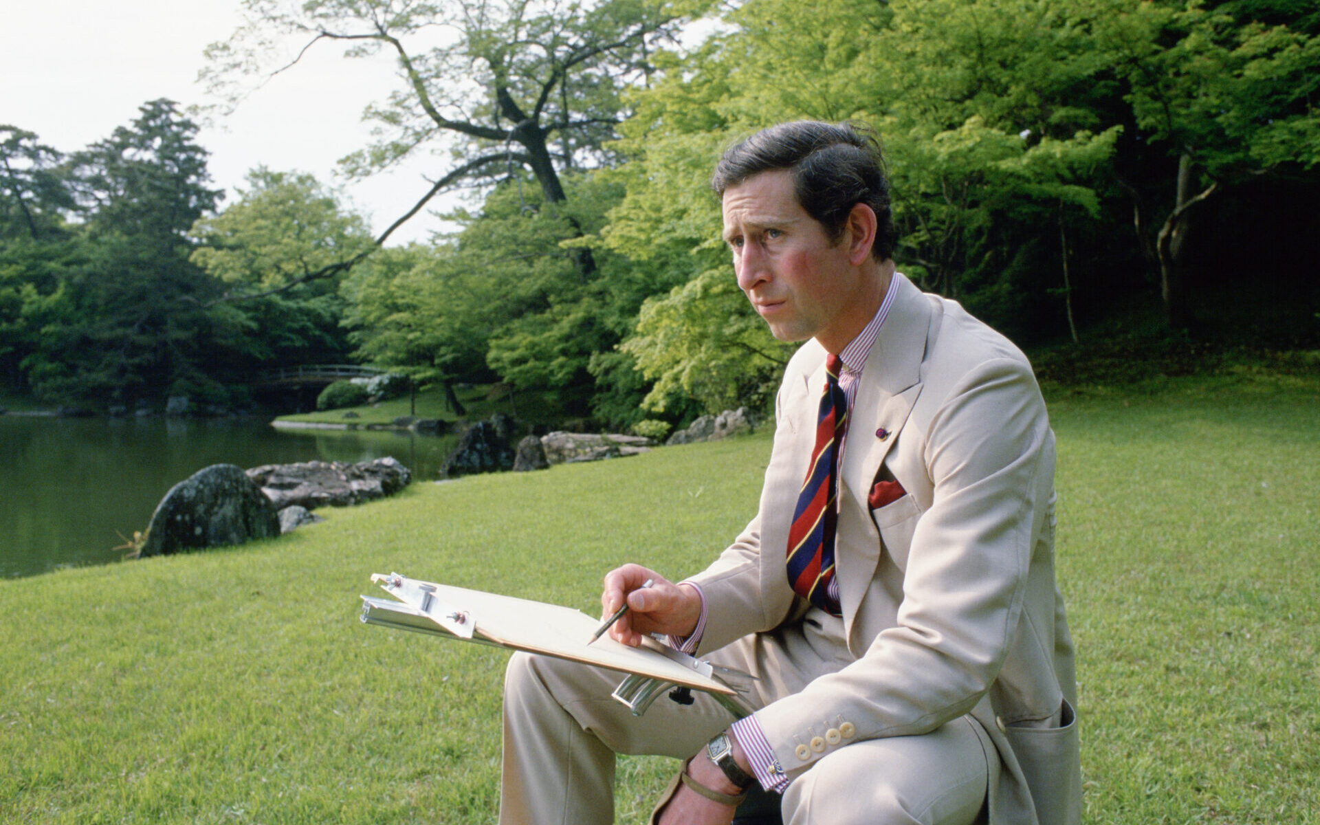 JAPAN - MAY 08: Prince Charles sketching in the gardens of Omiya Palace during a break in his official tour of Japan. (Photo by Tim Graham Photo Library via Getty Images)